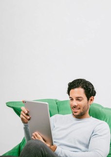 Smiley man having fun with tablet