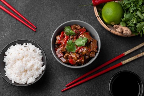 Top view asian dish with rice chopsticks