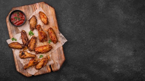 Top view fried chicken parts with sauce copy space