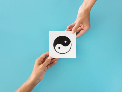 Top view hands exchanging ying yang symbol
