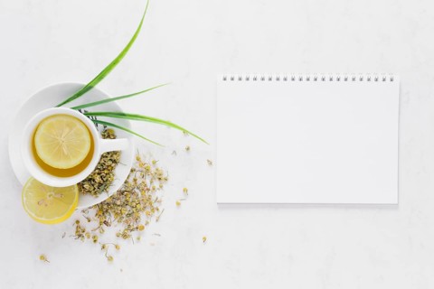 Top view lemon tea with notebook