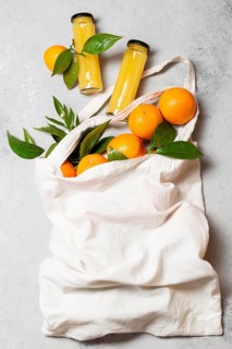 Top view oranges tote bag with juice bottles