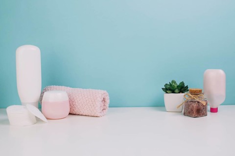 Towel cotton pads near cosmetics bottles