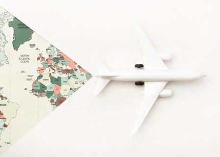 Travel concept with world map toy plane