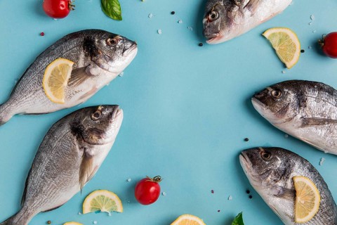 Uncooked seafood fish with lemon tomatoes