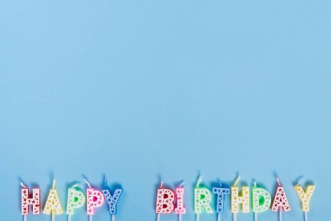 Unlit birthday candles with letters
