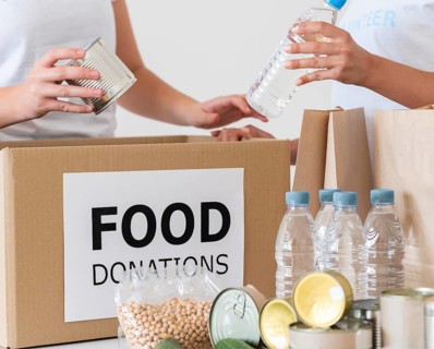 Volunteers with box water bottles donation