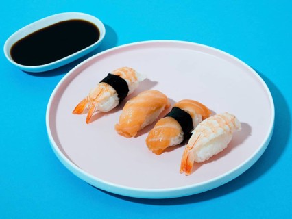 White sushi plate soy sauce bowl blue background