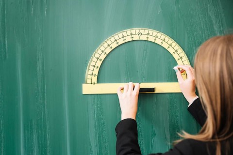 Woman drawing geometrical figure blackboard