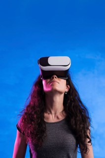 Woman using virtual reality headset outdoors
