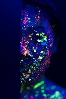 Woman with fluorescent make up half face