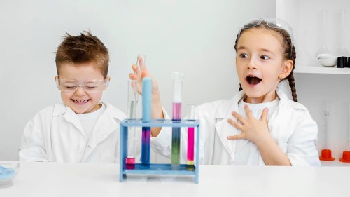 Young child scientists having fun doing experiments laboratory