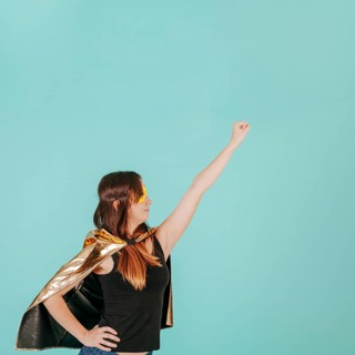 Young superwoman flying pose