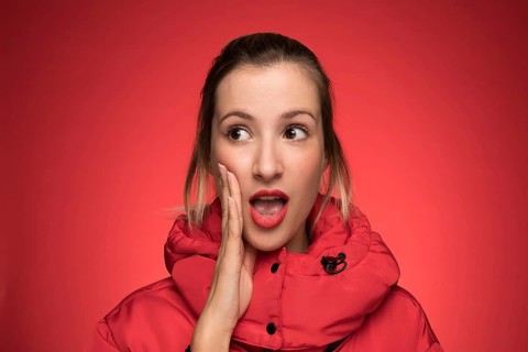 Young woman red winter coat shouting sign