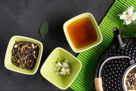 Assortment dry tea herb black slate backdrop