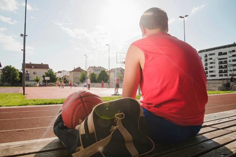 Basketball player sitting sports court
