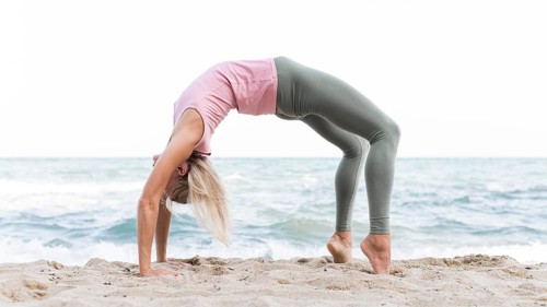 Beautiful woman doing yoga beach