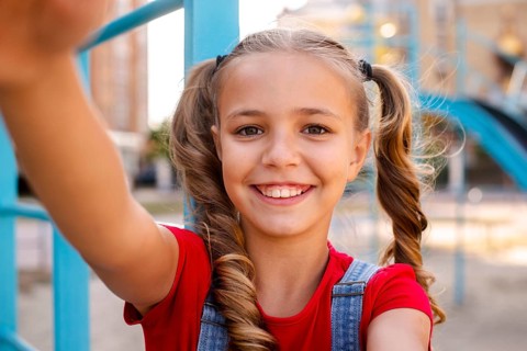 Blonde girl stretching out her hands camera