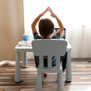 Boy talking with his teacher gesturing online school