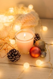 Burning candle with scarf wooden table