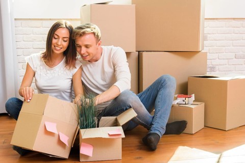Couple sitting floor inspect box