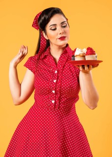 Cute pinup girl posing with cupcakes