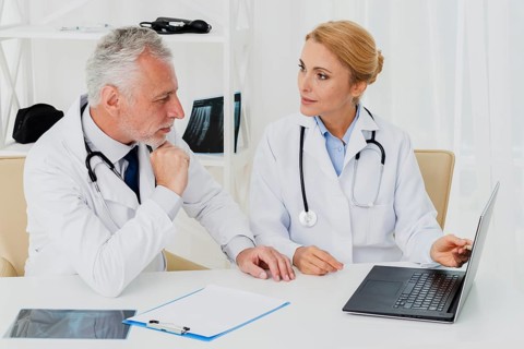 Doctors doing research laptop