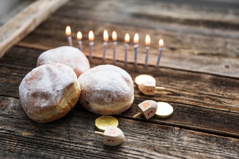 Doughnuts hanukkah symbols near candles