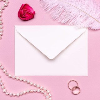 Elegant envelope surrounded by pearls wedding rings
