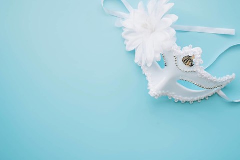 Elegant white mask blue background