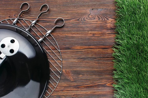 Elevated view barbecue appliance metallic skewer wooden background
