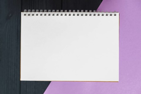 Elevated view spiral notepad colorful background