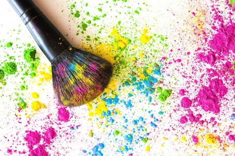 Face powder with makeup brush white backdrop
