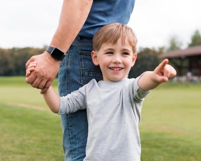 Father son holding hands park
