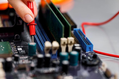 Female technician with computer motherboard