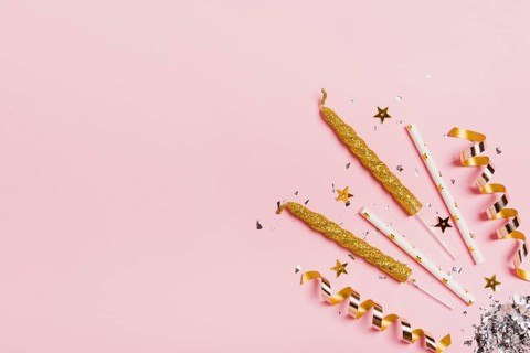 Flat lay copy space frame with candles glitter pink background