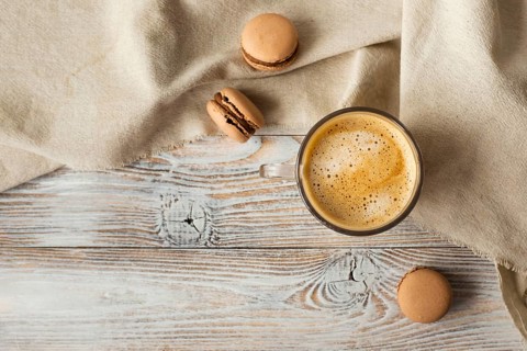 Flat lay cup coffee macarons