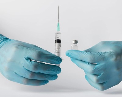 Front view doctor putting vaccine syringe