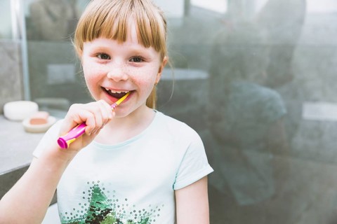 Girl brushing teeth