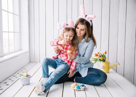 Girl mother bunny ears painting eggs easter