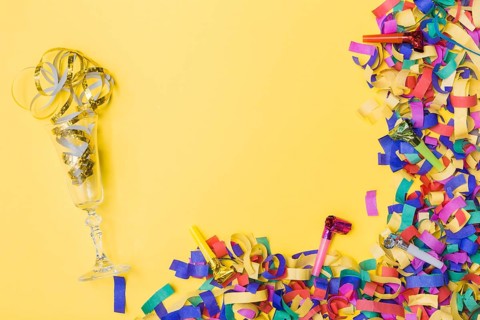 Glass party horns near confetti