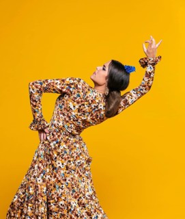 Medium shot woman bending back with orange background