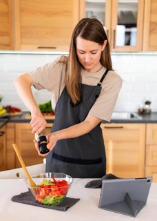 Medium shot woman spicing food