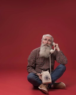 Old man holding telephone