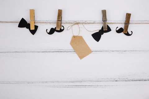 Ornament paper bow tie near mustache tag thread