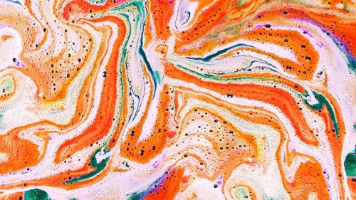 Overhead view color bath bomb foam water