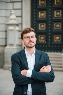 Portrait confident young businessman with his arms crossed