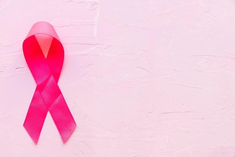 Realistic pink ribbon showing breast cancer awareness symbol pink stone