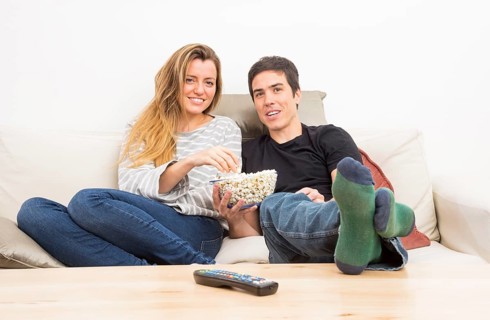 Remote control front couple eating popcorn