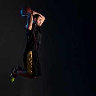 Side view basketball player dunking with copy space